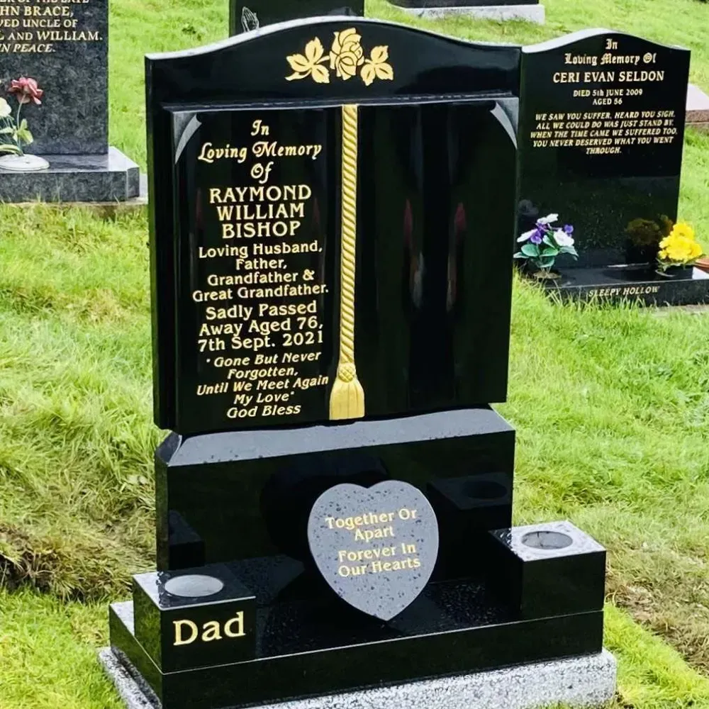 Black granite book memorial with carved roses, a gilded scroll and gold leaf inscription by FR Terrazzo