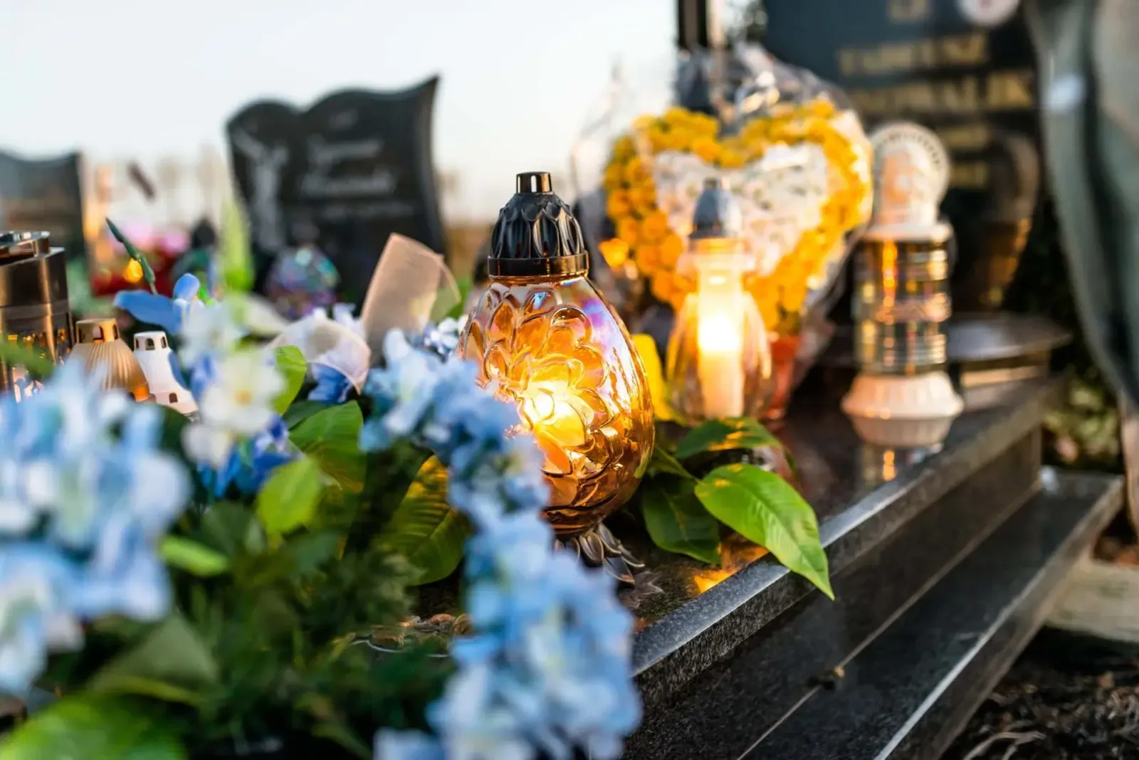 Flowers and lit candles laid at a graveside in South Wales