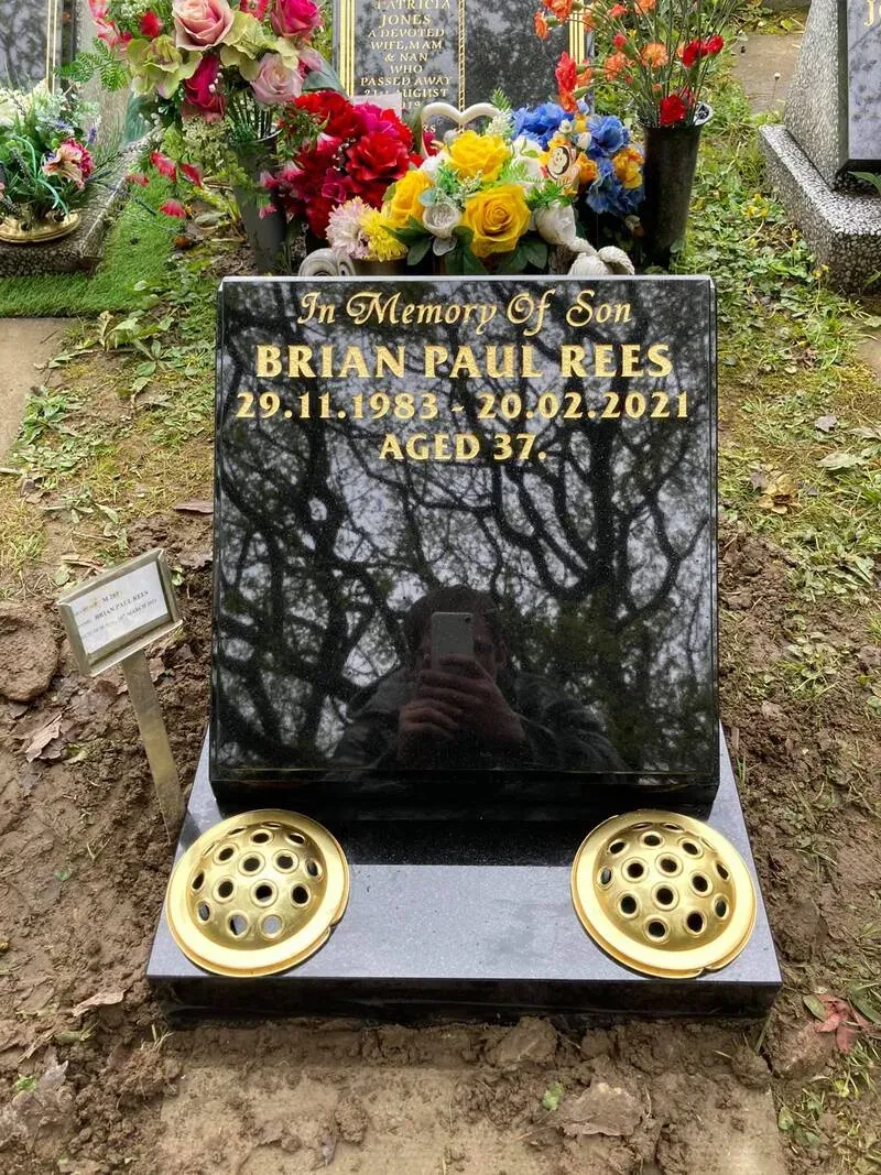 Black granite ogee headstone with gold leaf lettering, brass flower vases and a polished kerb front by FR Terrazzo, Rhondda Cynon Taff