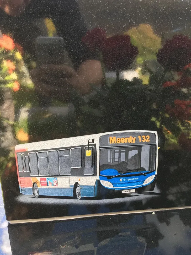 Black granite memorial with a full-colour etched and hand-painted bus, a fully bespoke piece of memorial artwork by FR Terrazzo, Rhondda Cynon Taff