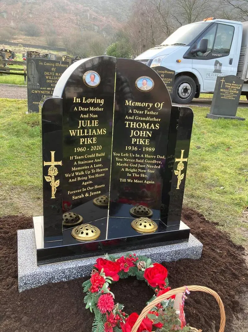 Double memorial in black granite with twin round-top tablets, ceramic photograph insets and gilded crosses and roses by FR Terrazzo, Rhondda Cynon Taff