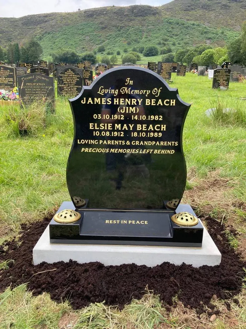 Black granite shaped-top headstone with gold leaf lettering on a light grey granite base by FR Terrazzo, Rhondda Cynon Taff