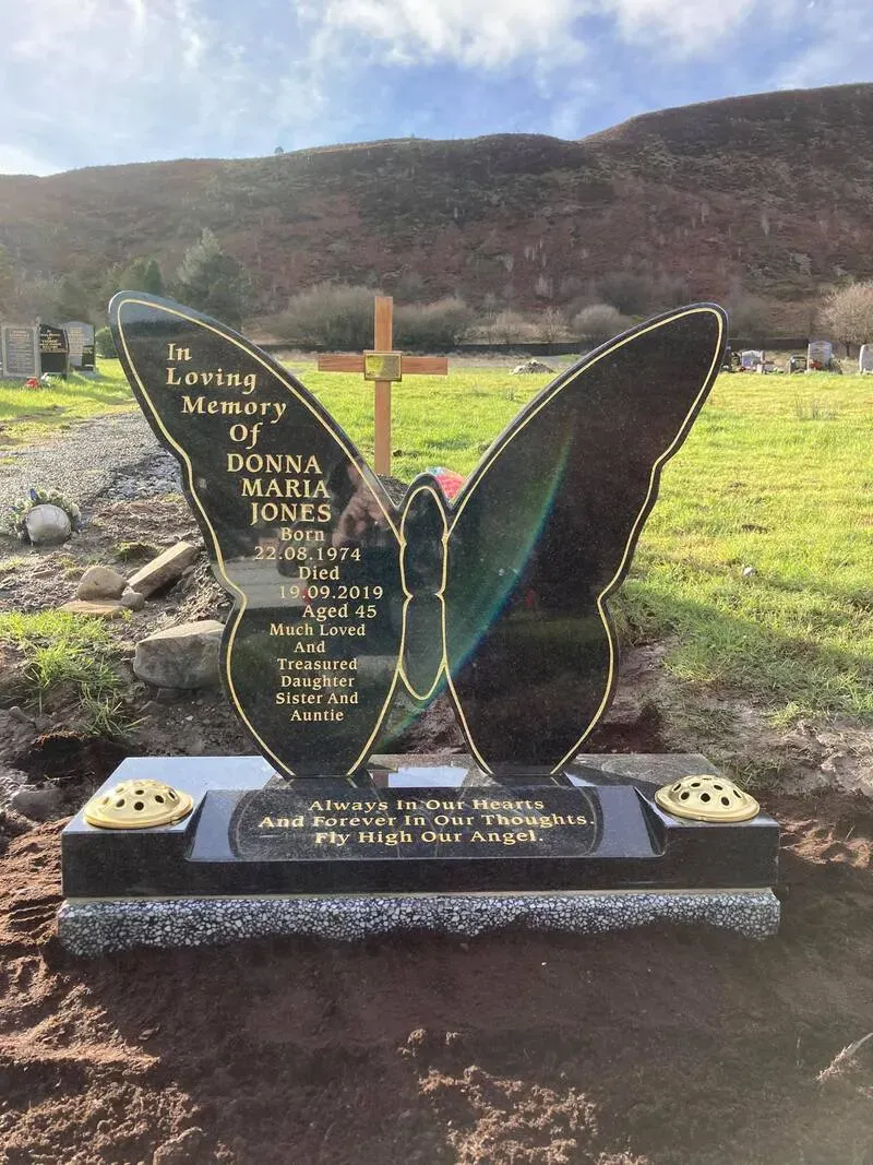 Bespoke butterfly-shaped etched memorial with a carved cross and polished granite base by FR Terrazzo