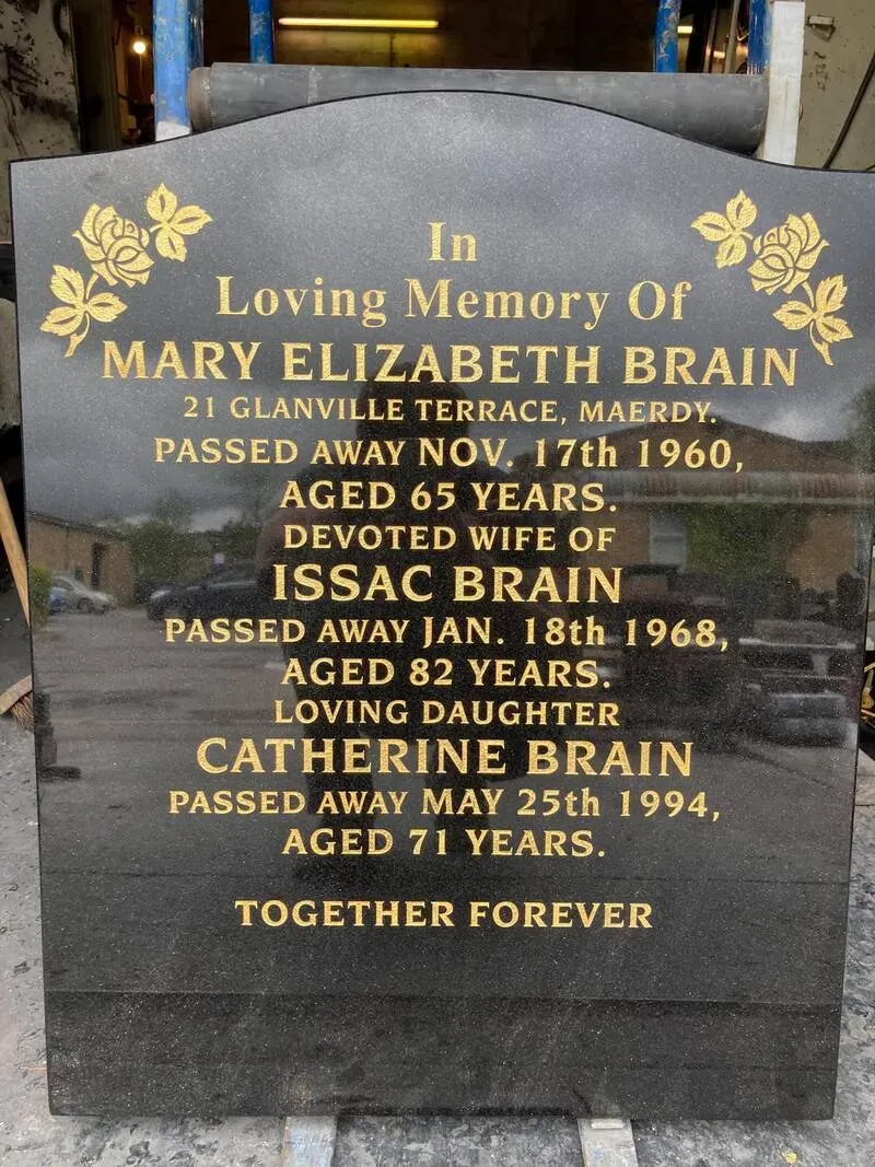 Large black granite family memorial with gilded roses and a multi-name gold leaf inscription by FR Terrazzo