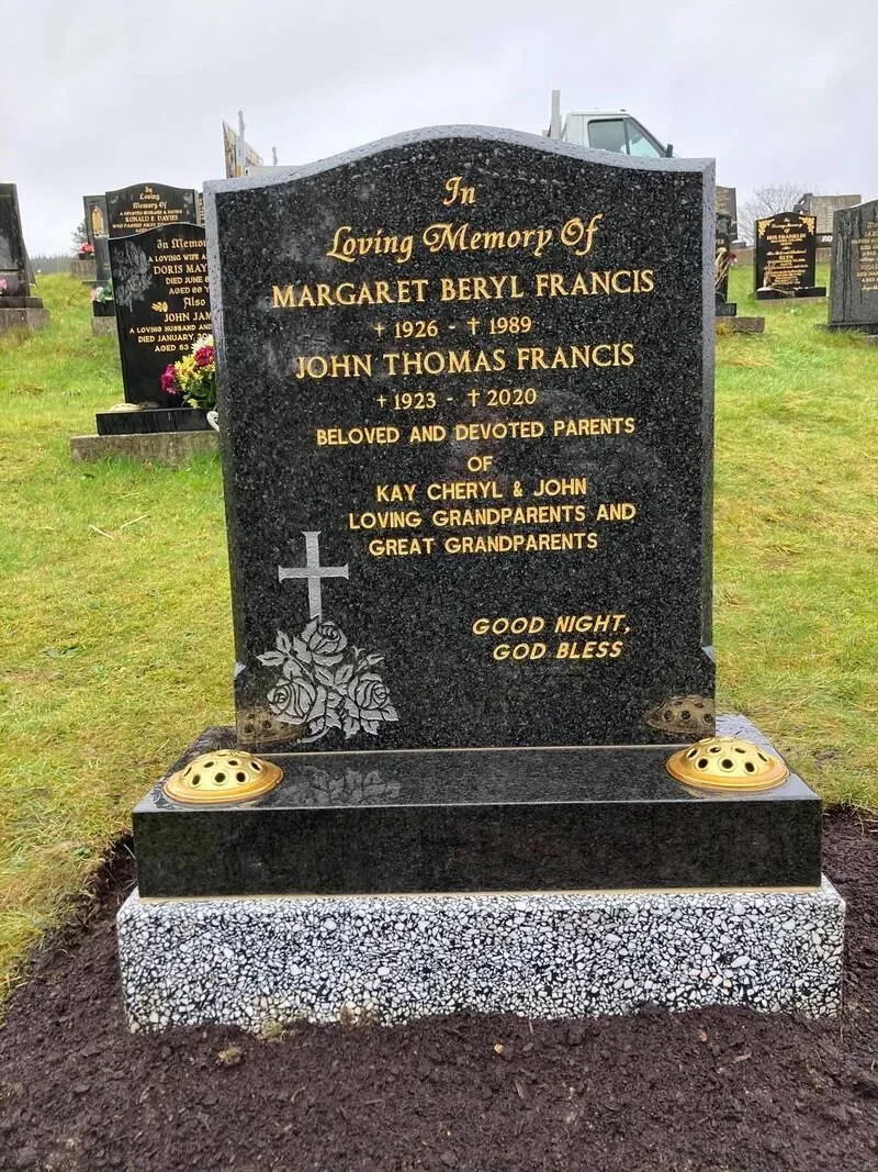 Black granite family headstone with a gilded cross, etched roses and gold leaf lettering by FR Terrazzo, Rhondda Cynon Taff