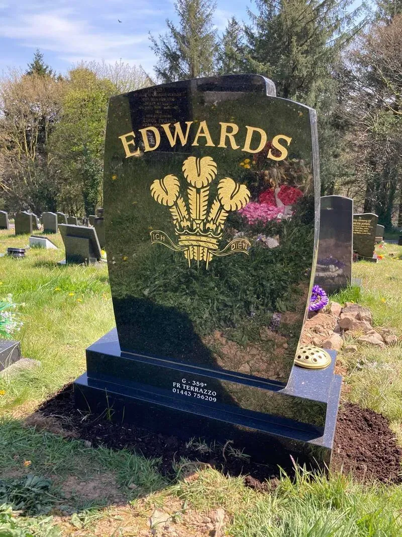 Contemporary sweeping black granite memorial with hand-gilded Prince of Wales feathers by FR Terrazzo, Rhondda Cynon Taff